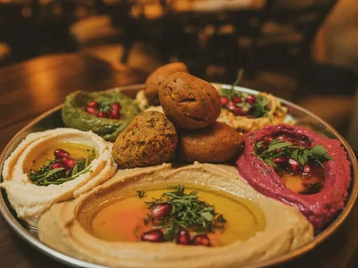 Menu Hero Mezze at House of Legends Classic Hummus - Creamy chickpea purée, tahini, olive oil, warm pita